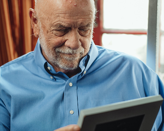 older man looking at photo