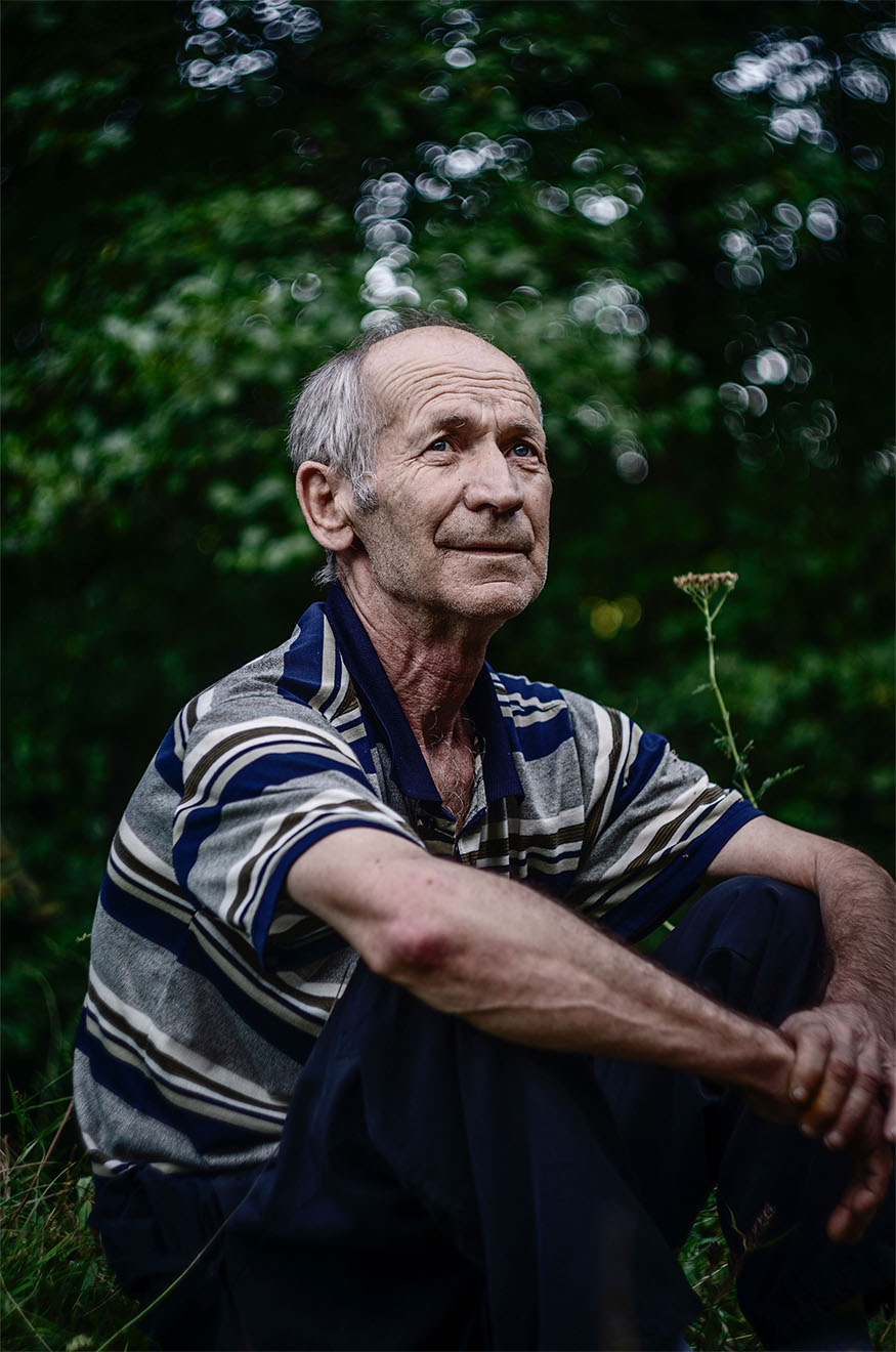older man sitting in garden