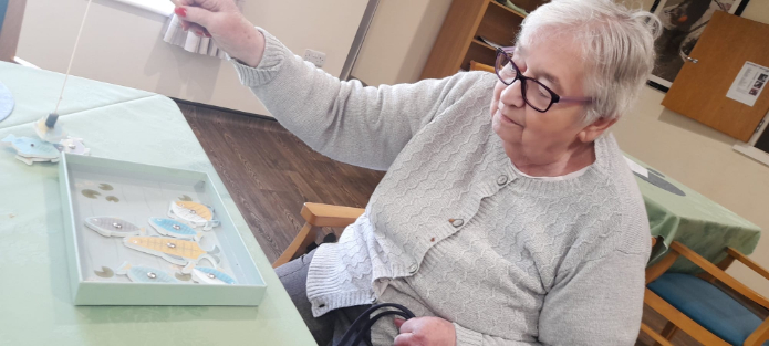 Resident enjoying an activity at the table