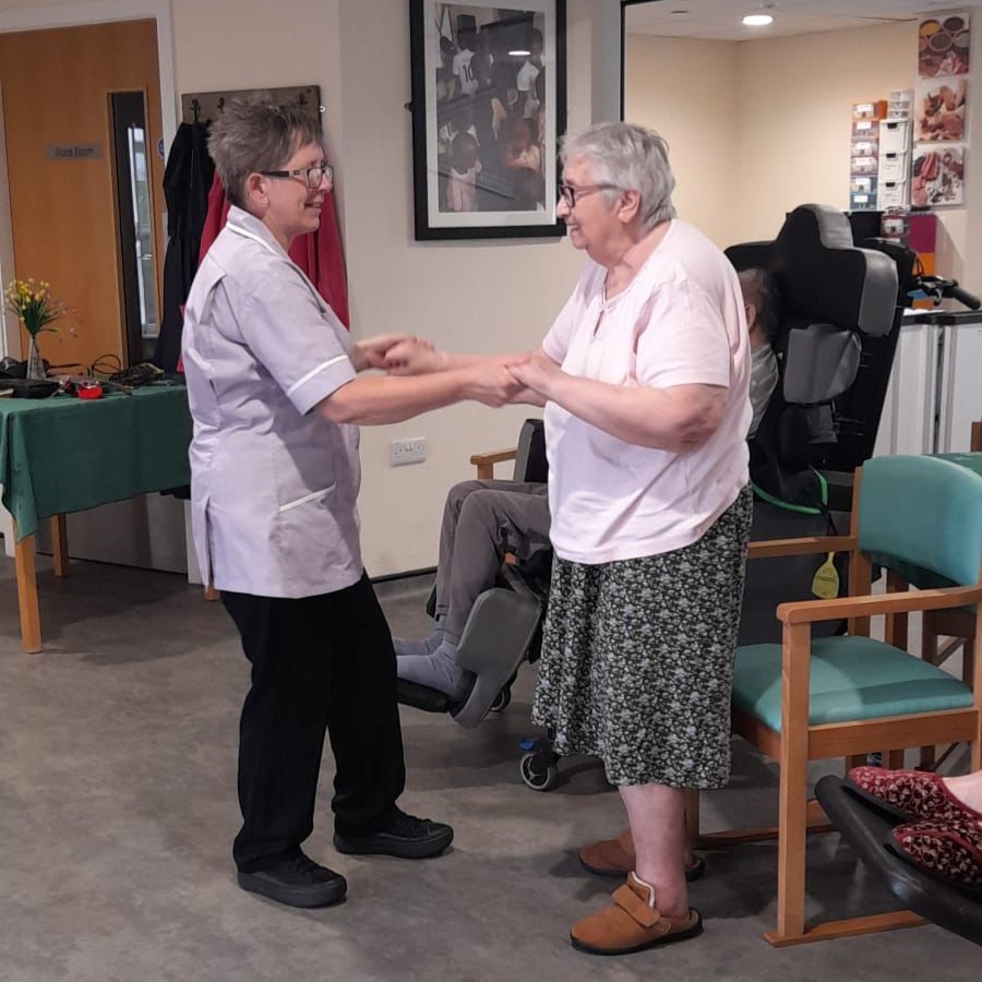Resident and carer dancing
