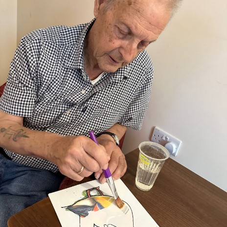 Resident painting a picture