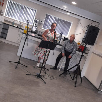 two performers singing in a care home